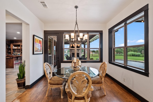 215 Thornhill Cir, Double Oak, TX 75077 - dining room with a chandelier, baseboards, and wood finished floors