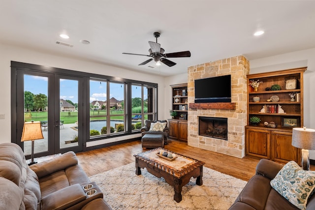 215 Thornhill Cir, Double Oak, TX 75077 - living room with ceiling fan, a fireplace, french doors, light wood finished floors, and recessed lighting
