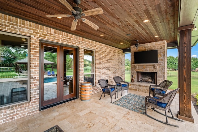 215 Thornhill Cir, Double Oak, TX 75077 - view of patio / terrace with an outdoor stone fireplace, ceiling fan, and french doors