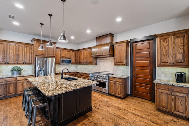 215 Thornhill Cir, Double Oak, TX 75077 - kitchen with premium appliances, a sink, backsplash, brown cabinets, and recessed lighting