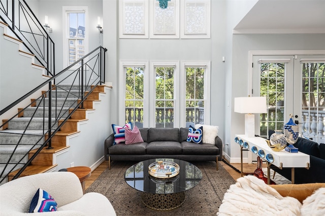 3702 Holland Ave Unit 1, Dallas, TX 75219 - living room featuring baseboards, wood finished floors, stairs, french doors, and ornamental molding