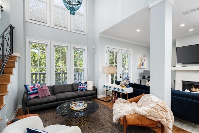 3702 Holland Ave Unit 1, Dallas, TX 75219 - living room with a high end fireplace, ornamental molding, baseboards, recessed lighting, and stairs