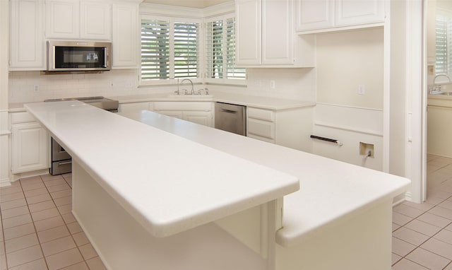 332 Diamond Oaks Dr, Hudson Oaks, TX 76087 - kitchen with appliances with stainless steel finishes, light tile patterned floors, backsplash, and a sink