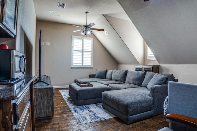 3420 Grayson Ct, Hurst, TX 76054 - living area featuring ceiling fan, vaulted ceiling, dark wood finished floors, and baseboards