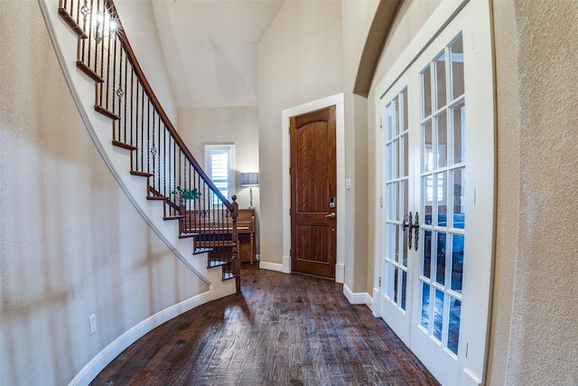 3420 Grayson Ct, Hurst, TX 76054 - foyer featuring wood finished floors, a towering ceiling, stairway, baseboards, and french doors