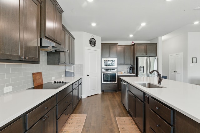 3385 Dps Tower Rd, Perrin, TX 76486 - kitchen with stainless steel appliances, under cabinet range hood, light countertops, dark brown cabinetry, and recessed lighting