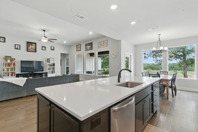 3385 Dps Tower Rd, Perrin, TX 76486 - kitchen with stainless steel dishwasher, light wood finished floors, a kitchen island with sink, light countertops, and recessed lighting