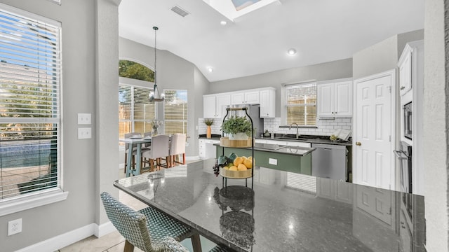 5709 Courtney Cir, Haltom City, TX 76137 - kitchen with stainless steel appliances, a sink, white cabinets, tasteful backsplash, and baseboards