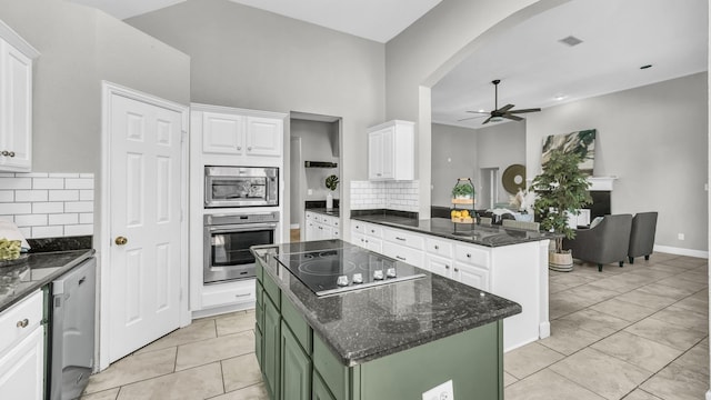 5709 Courtney Cir, Haltom City, TX 76137 - kitchen featuring appliances with stainless steel finishes, a ceiling fan, green cabinetry, arched walkways, and white cabinetry