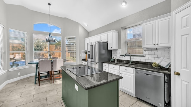 5709 Courtney Cir, Haltom City, TX 76137 - kitchen featuring appliances with stainless steel finishes, a sink, vaulted ceiling, a chandelier, and white cabinetry