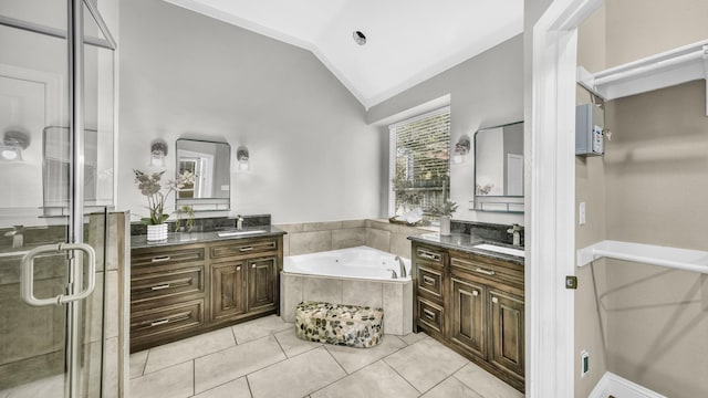 5709 Courtney Cir, Haltom City, TX 76137 - full bathroom with two vanities, a garden tub, a shower stall, lofted ceiling, and tile patterned flooring
