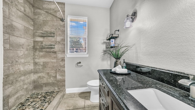 5709 Courtney Cir, Haltom City, TX 76137 - bathroom with tile patterned flooring, tiled shower, toilet, and double vanity