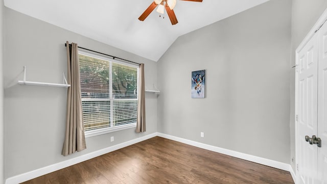 5709 Courtney Cir, Haltom City, TX 76137 - empty room featuring ceiling fan, baseboards, vaulted ceiling, and dark wood finished floors