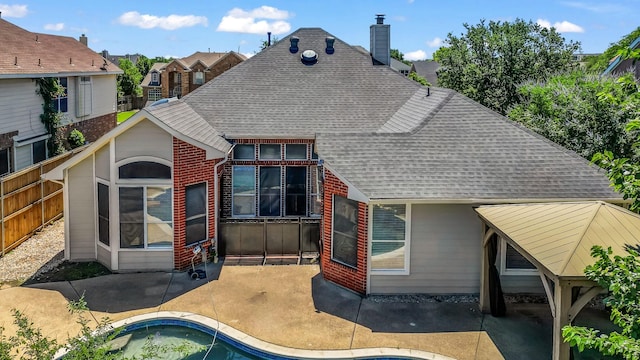 5709 Courtney Cir, Haltom City, TX 76137 - rear view of property featuring roof with shingles, a chimney, a patio, and an outdoor pool