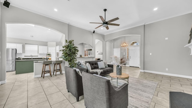 5709 Courtney Cir, Haltom City, TX 76137 - living room with arched walkways, ceiling fan, recessed lighting, light tile patterned floors, and crown molding