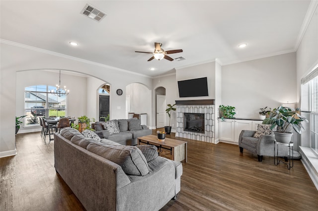 386 Cavitt Ct, Robinson, TX 76706 - living area featuring arched walkways, a fireplace, dark wood-type flooring, ceiling fan, and crown molding