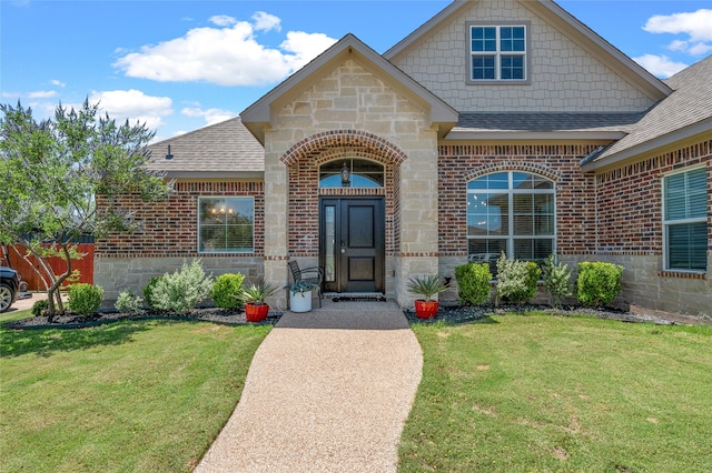386 Cavitt Ct, Robinson, TX 76706 - entrance to property featuring roof with shingles, brick siding, and stone siding