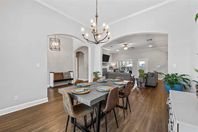 386 Cavitt Ct, Robinson, TX 76706 - dining area featuring arched walkways, a ceiling fan, a chandelier, dark wood-style floors, and baseboards