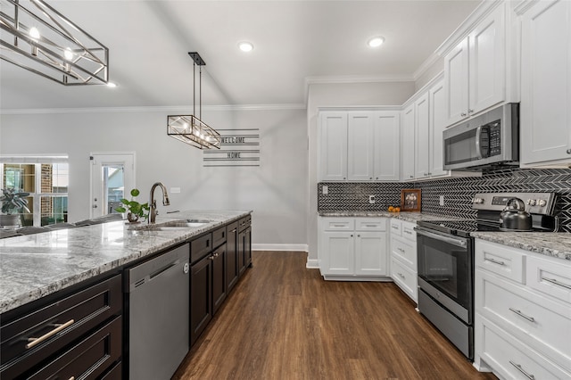 386 Cavitt Ct, Robinson, TX 76706 - kitchen with stainless steel appliances, a sink, white cabinets, tasteful backsplash, and ornamental molding