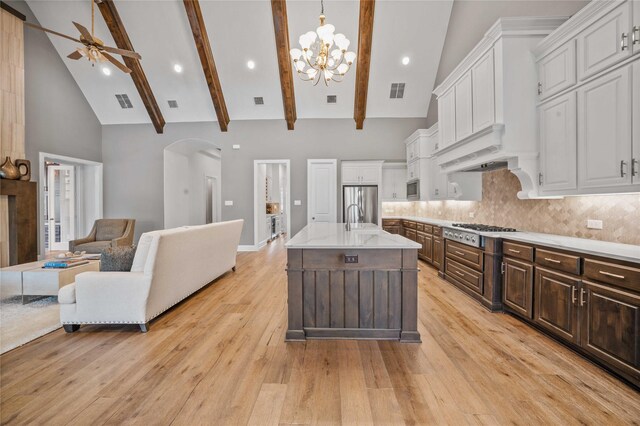 6286 Brentway Rd, Frisco, TX 75034 - kitchen featuring open floor plan, stainless steel appliances, arched walkways, ceiling fan, and a chandelier