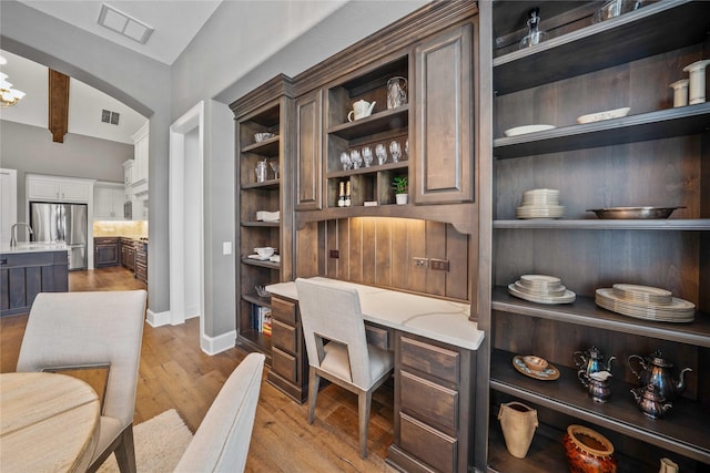 6286 Brentway Rd, Frisco, TX 75034 - office space featuring light wood-style floors, arched walkways, a sink, and baseboards