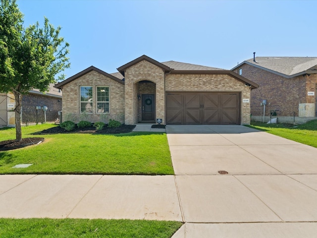 4148 Agatha Ln, Celina, TX 76227 - french provincial home featuring a garage, brick siding, concrete driveway, and a front lawn