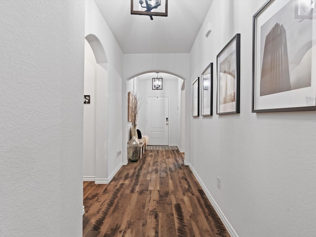 4148 Agatha Ln, Celina, TX 76227 - corridor featuring arched walkways, a textured wall, baseboards, and wood finished floors