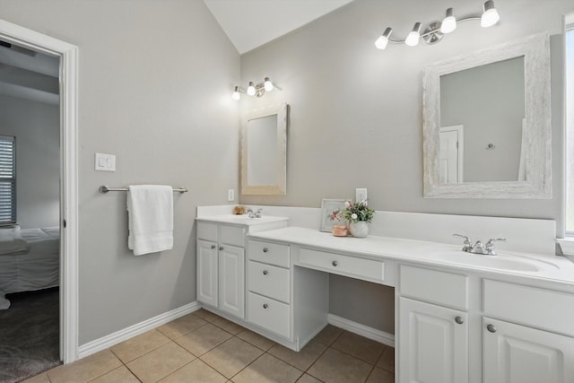 736 Kilbridge Ln, Coppell, TX 75019 - bathroom featuring tile patterned flooring, double vanity, ensuite bathroom, baseboards, and lofted ceiling