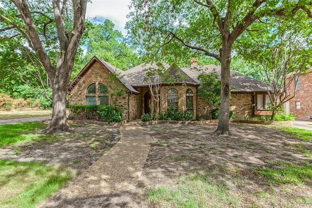 1719 Timberway Dr, Richardson, TX 75082 - view of front of house featuring brick siding, a chimney, and roof with shingles