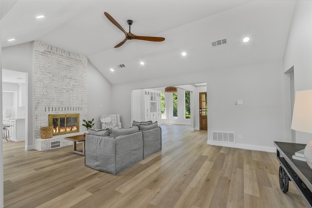 336 Pebble Knl, Highland Village, TX 75077 - living room with ceiling fan, light wood-style flooring, high vaulted ceiling, a fireplace, and baseboards