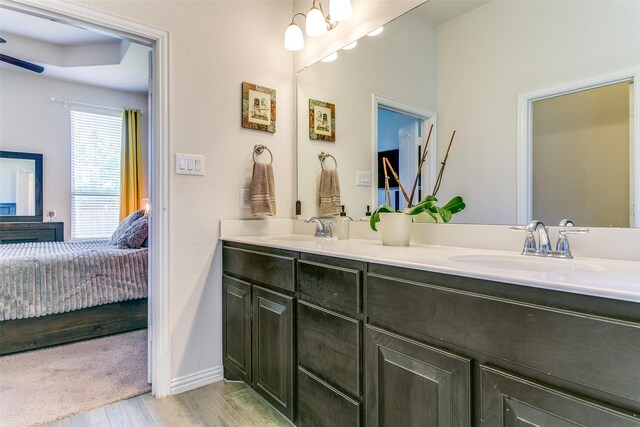 4012 Gennaker Dr, Denton, TX 76210 - ensuite bathroom featuring double vanity, wood finished floors, and a ceiling fan