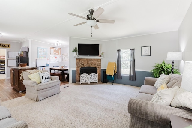 239 County Road 3586, Paradise, TX 76073 - living area with a ceiling fan, crown molding, and a stone fireplace