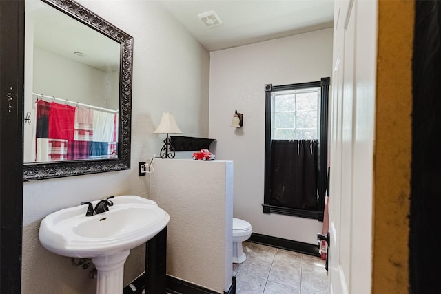 239 County Road 3586, Paradise, TX 76073 - bathroom with toilet, tile patterned floors, and a shower with shower curtain