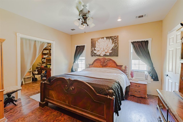 239 County Road 3586, Paradise, TX 76073 - bedroom with cooling unit, wood finished floors, and a ceiling fan