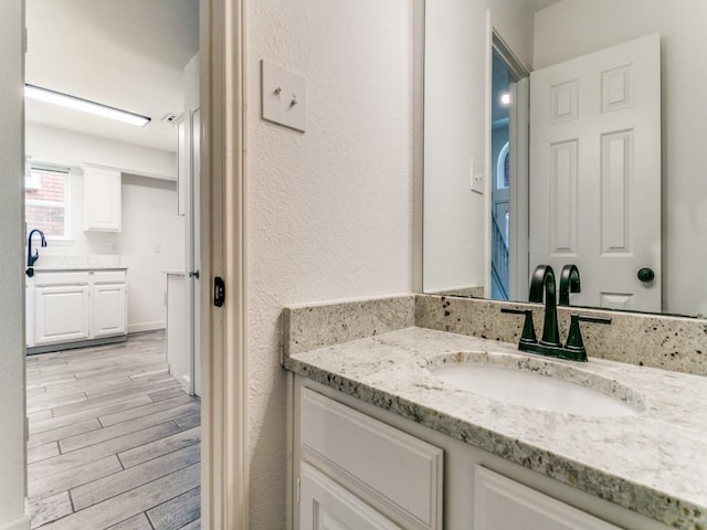 117 Summer Place Dr, Coppell, TX 75019 - bathroom with vanity, wood finished floors, and a textured wall