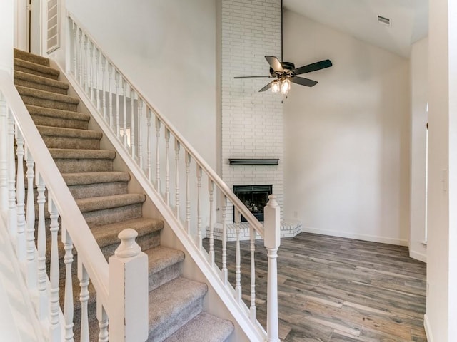117 Summer Place Dr, Coppell, TX 75019 - staircase with high vaulted ceiling, wood finished floors, a ceiling fan, a fireplace, and baseboards