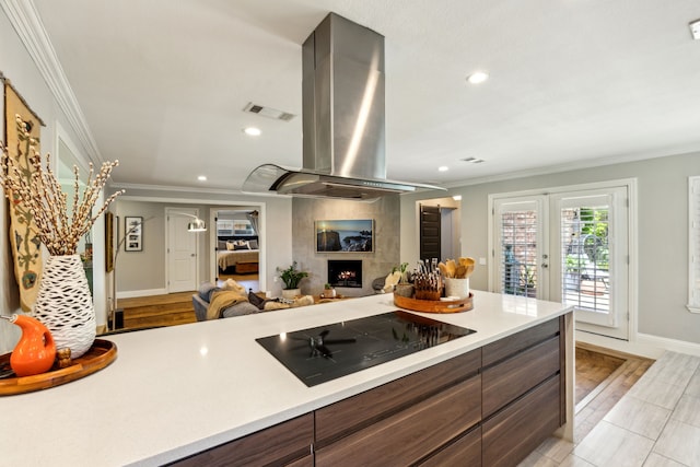 605 Cliffside Dr, Richardson, TX 75080 - kitchen featuring island exhaust hood, black electric stovetop, crown molding, light countertops, and french doors