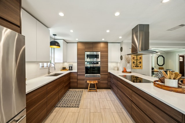 605 Cliffside Dr, Richardson, TX 75080 - kitchen with appliances with stainless steel finishes, a sink, island range hood, recessed lighting, and light countertops