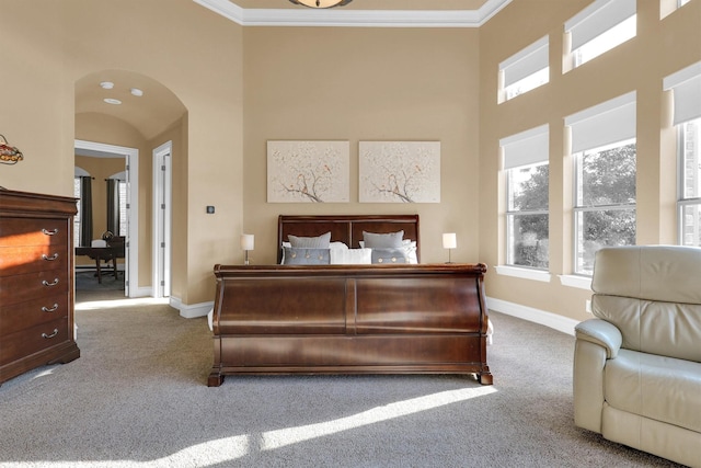 11667 Bent Creek Trl, Frisco, TX 75033 - bedroom featuring carpet, crown molding, arched walkways, and a towering ceiling