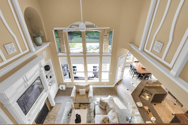 11667 Bent Creek Trl, Frisco, TX 75033 - living area featuring a towering ceiling and a fireplace with flush hearth
