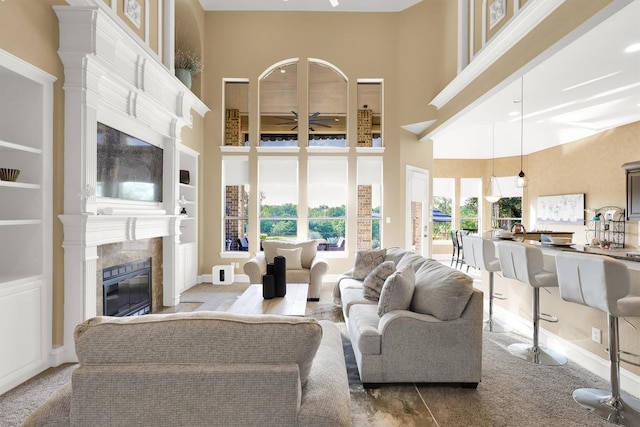 11667 Bent Creek Trl, Frisco, TX 75033 - living room with a high ceiling, a fireplace, ceiling fan, and carpet flooring