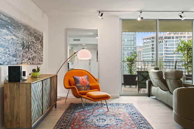 3310 Fairmount St Unit 16B, Dallas, TX 75201 - sitting room featuring wood finished floors, expansive windows, and rail lighting