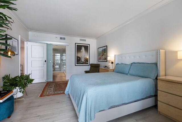 3310 Fairmount St Unit 16B, Dallas, TX 75201 - bedroom featuring crown molding and wood finished floors