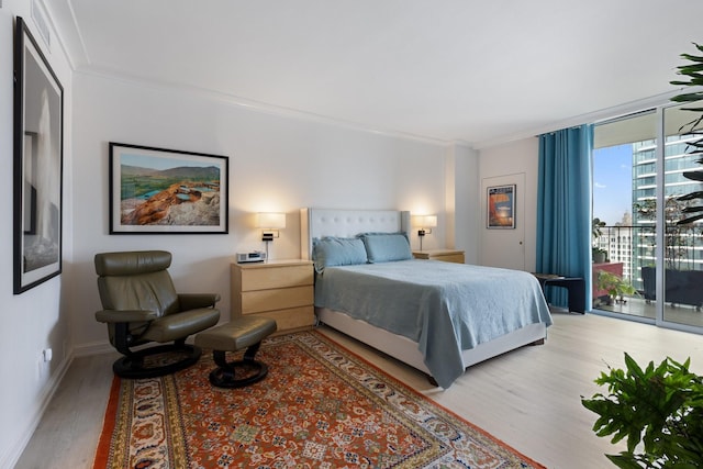 3310 Fairmount St Unit 16B, Dallas, TX 75201 - bedroom with access to outside, light wood-style flooring, ornamental molding, and baseboards
