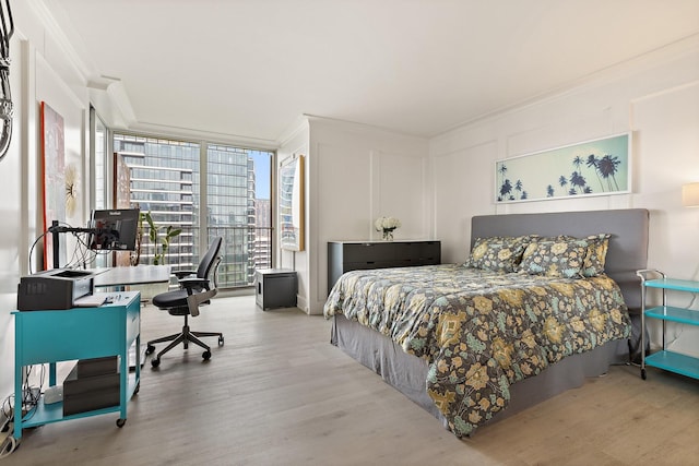 3310 Fairmount St Unit 16B, Dallas, TX 75201 - bedroom with ornamental molding, wood finished floors, a desk, and expansive windows