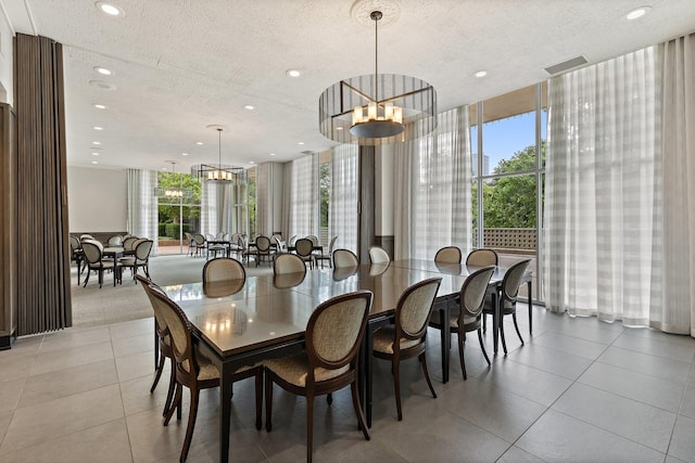 3310 Fairmount St Unit 16B, Dallas, TX 75201 - dining area featuring a textured ceiling, recessed lighting, light tile patterned flooring, floor to ceiling windows, and a chandelier
