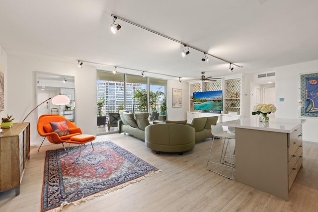 3310 Fairmount St Unit 16B, Dallas, TX 75201 - living area featuring track lighting, light wood-type flooring, and ceiling fan