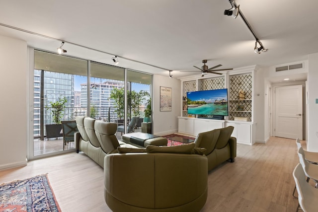 3310 Fairmount St Unit 16B, Dallas, TX 75201 - living area with track lighting, light wood-style floors, a ceiling fan, and floor to ceiling windows