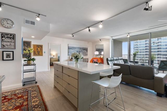 3310 Fairmount St Unit 16B, Dallas, TX 75201 - kitchen with rail lighting, a center island, modern cabinets, and open floor plan