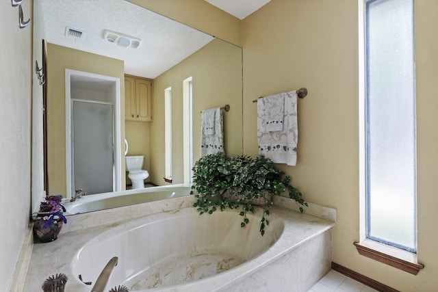 1720 Norwood Dr, Hurst, TX 76054 - bathroom featuring toilet, a shower stall, a garden tub, and tile patterned flooring